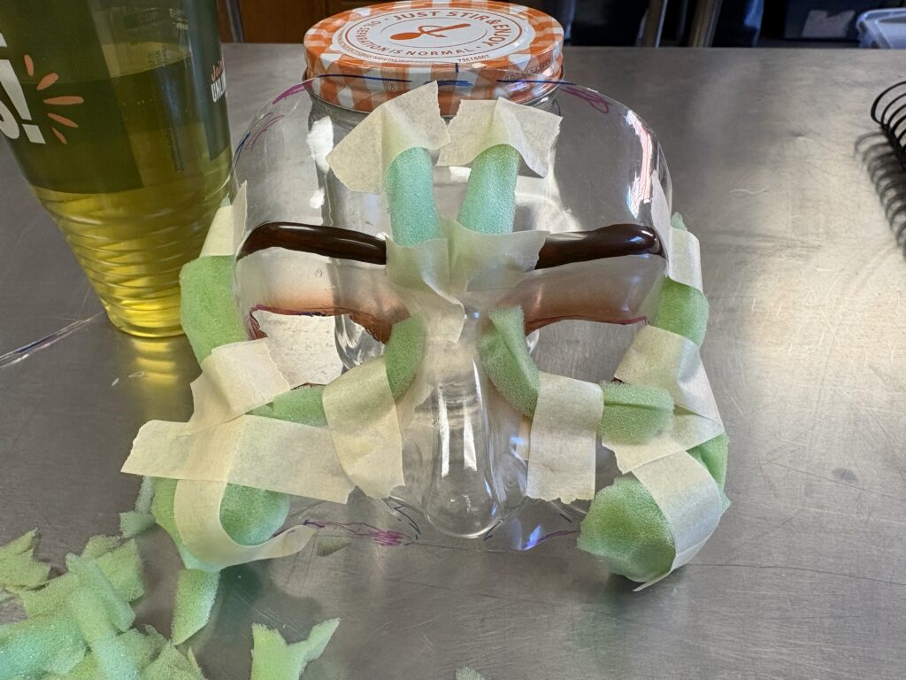 A clear half face mask with foam taped to it to create cheeks and winkles.